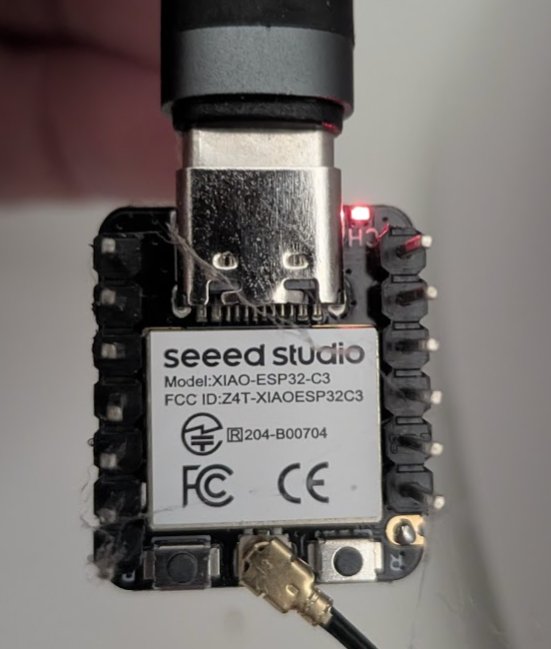 Seeed Studio XIAO ESP32-C3 board close-up, showing the USB-C port and external antenna connector